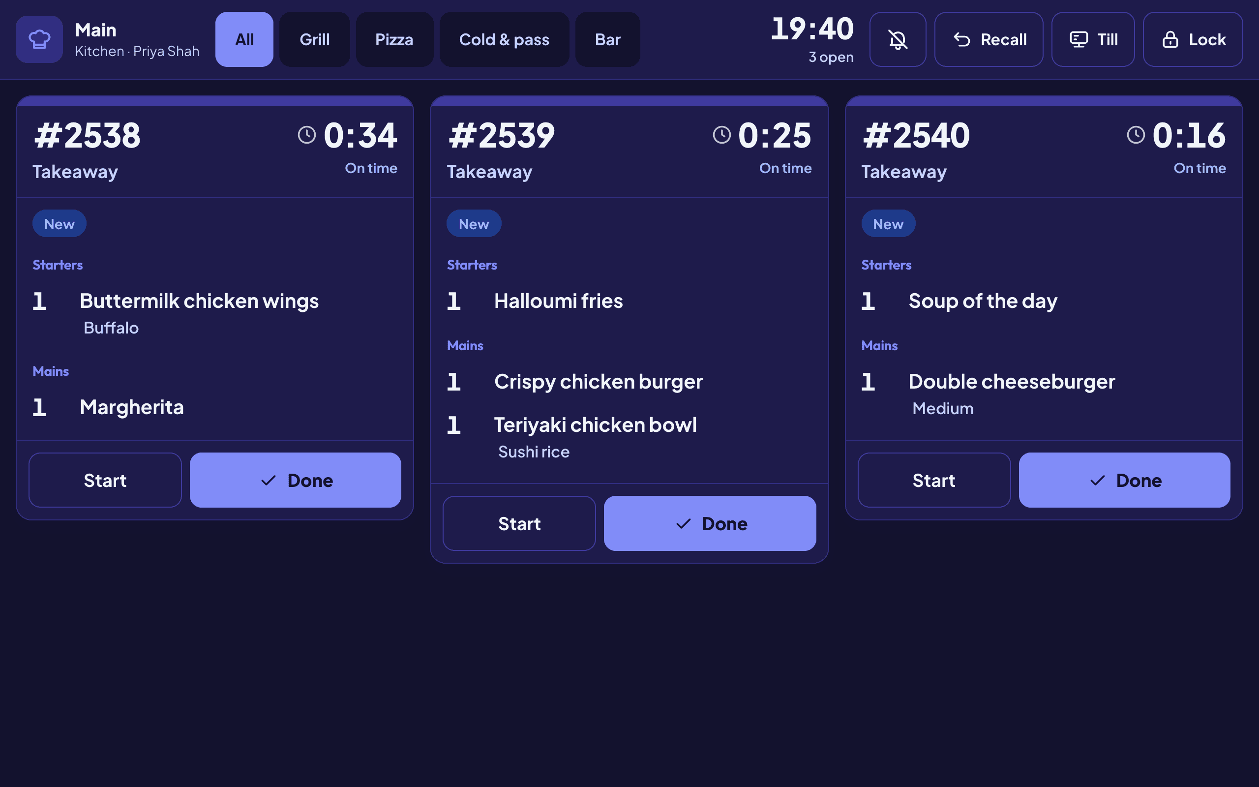The kitchen screen showing three new tickets split into starters and mains
